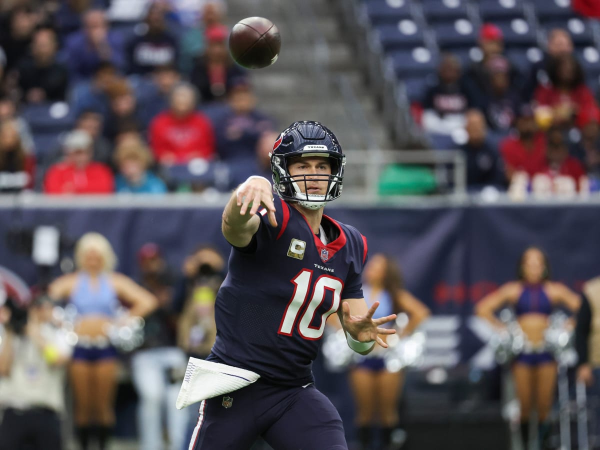 NASHVILLE, TN - DECEMBER 24: Houston Texans quarterback Davis Mills (10)  hands the ball off to Houston Texans running back Dare Ogunbowale (33)  during a game between the Tennessee Titans and the