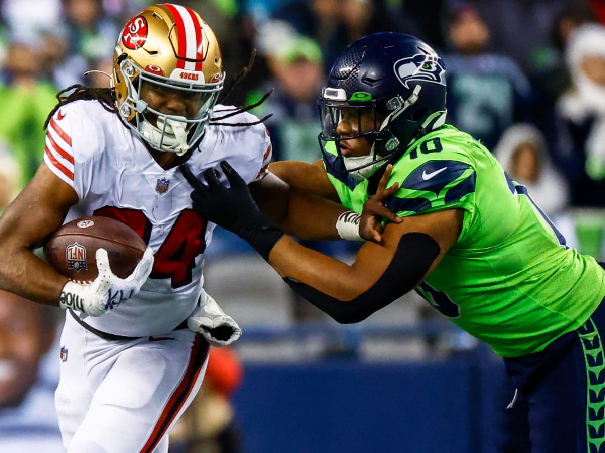 Jordan Mason of the San Francisco 49ers runs the ball during the