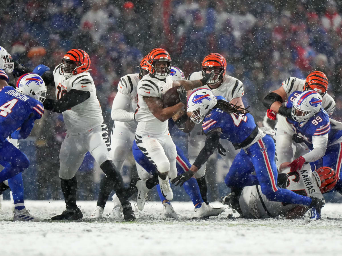 Cincinnati Bengals running back Joe Mixon (28) is tackled by the Buffalo  Bills during the first quarter of an NFL division round football game,  Sunday, Jan. 22, 2023, in Orchard Park, N.Y. (