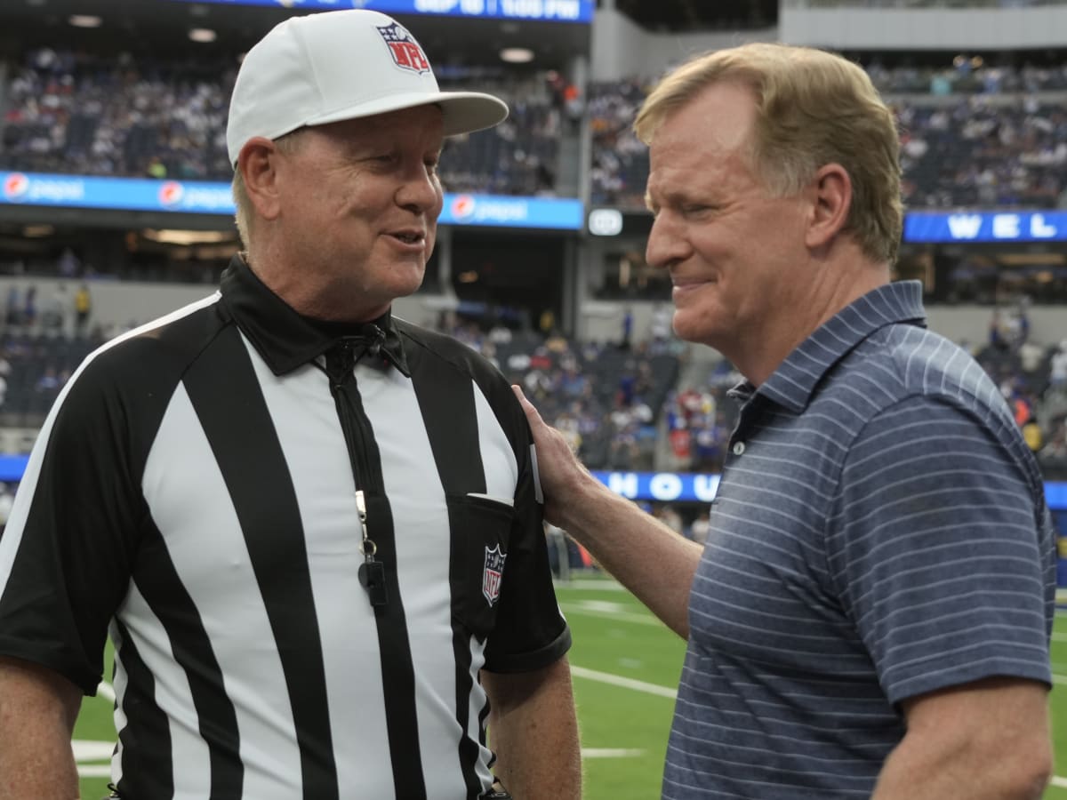 NFL referees discuss a penalty flag thrown during the second half