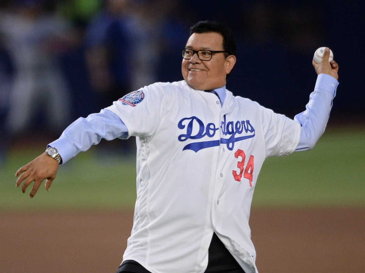 Retired Major League Baseball pitcher Fernando Valenzuela throws the  inaugural ball during the regular-season major league baseball game between  the San Diego Padres and the Los Angeles Dodgers in …