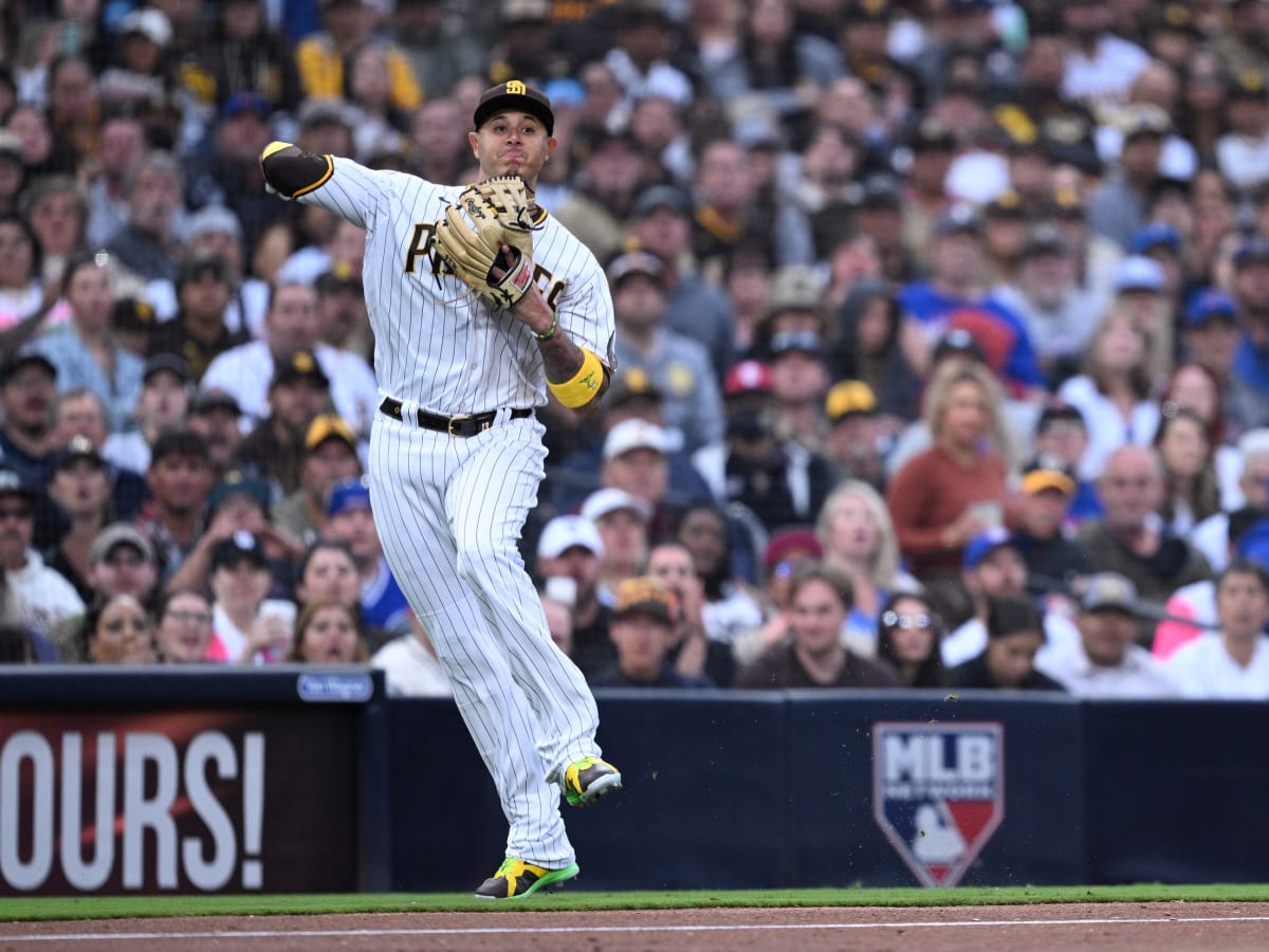 Manny Machado of the San Diego Padres fields the ball and throws