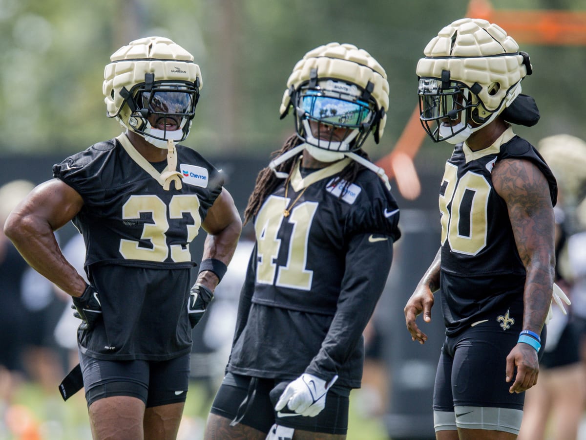 The reflection of New Orleans Saints running back Alvin Kamara (41) is seen  in his visor as he runs through drills at the team's NFL football minicamp  in Metairie, La., Thursday, June