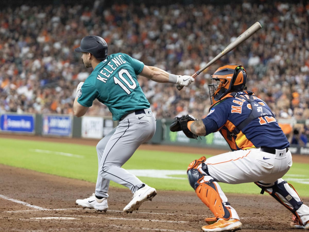 Seattle Mariners' Jarred Kelenic holds his head after a collision