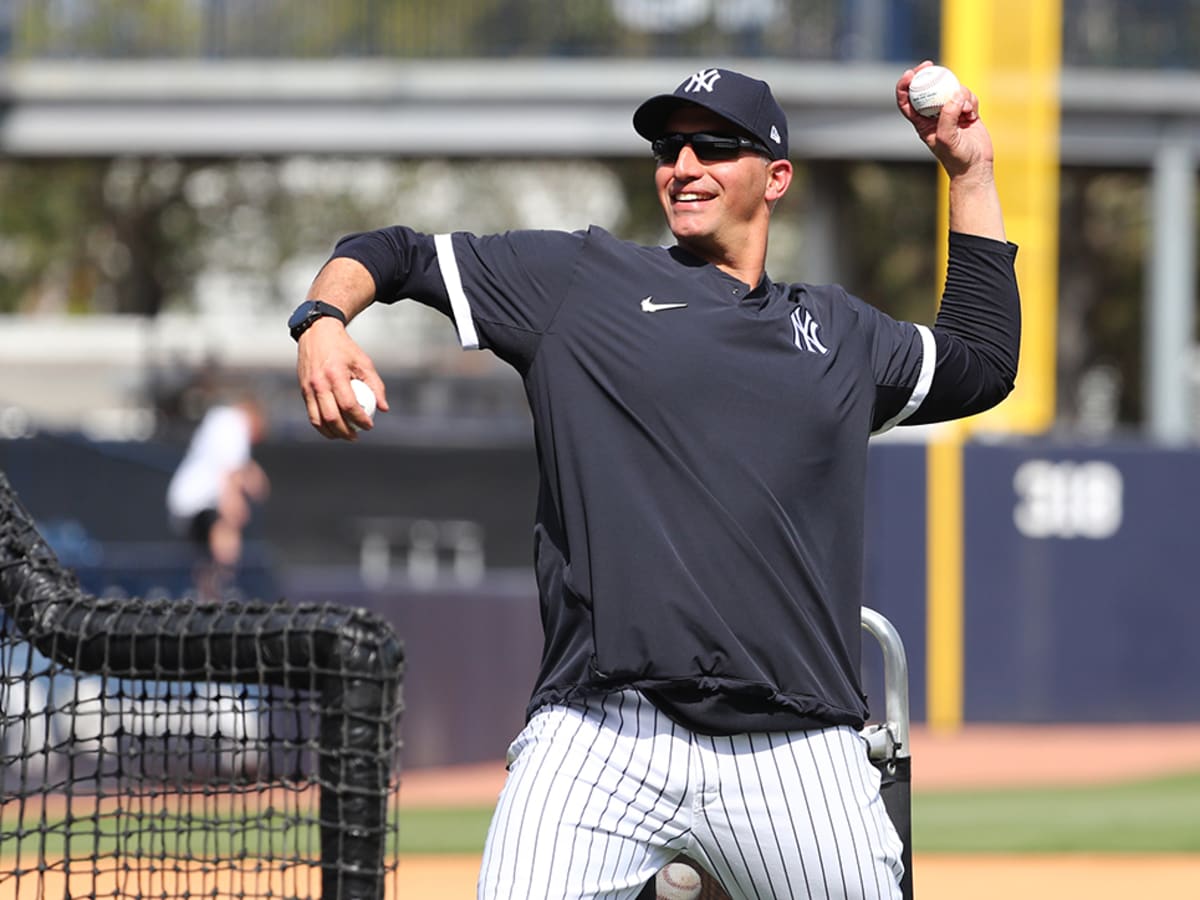 New York Yankees pitcher Andy Pettitte holds his glove to his face