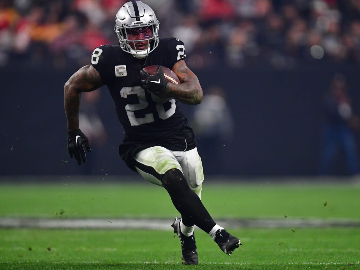 Davante Adams and Josh Jacobs of the Las Vegas Raiders stand on