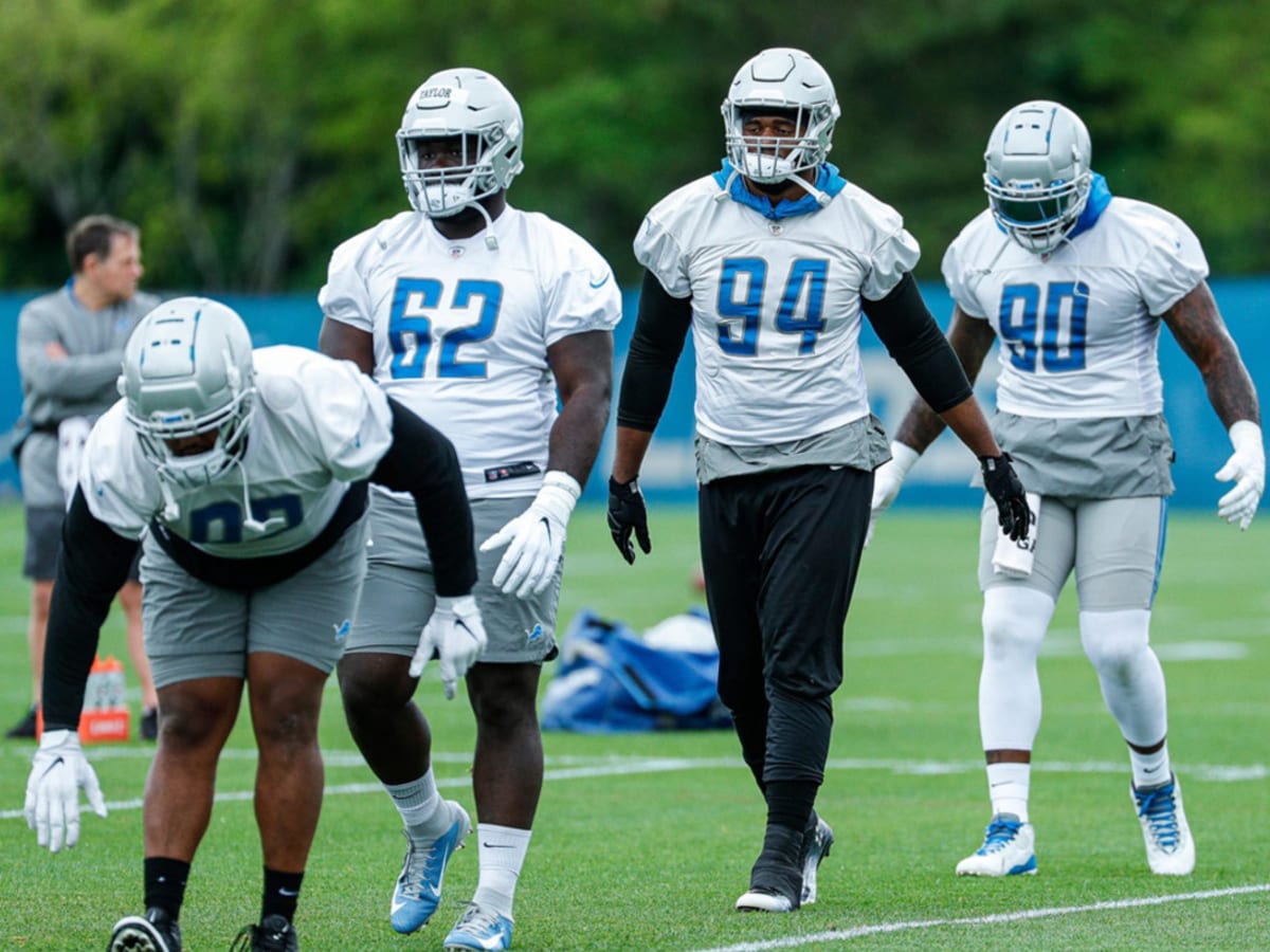 Detroit Lions defensive tackle John Penisini (98) talks with