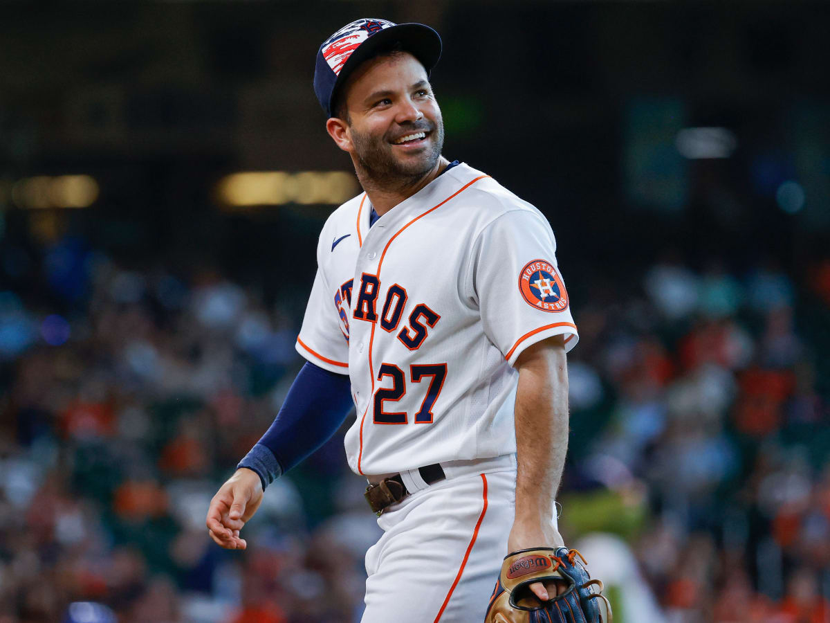 Houston Astros second baseman Jose Altuve holds the3 World Series  championship trophy during the Astros World Ser…