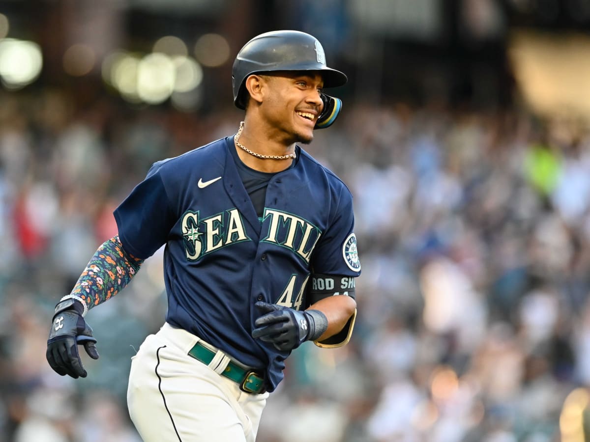 Seattle Mariners' Julio Rodriguez smiles while standing next to