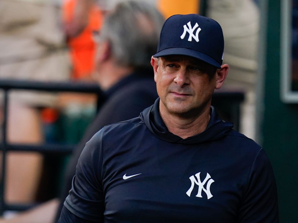 Aaron Boone puts on a Yankees cap and jersey after the New York Yankees  Introduce Aaron Boone as their new manager at Yankee Stadium in New York  City on December 6, 2017.