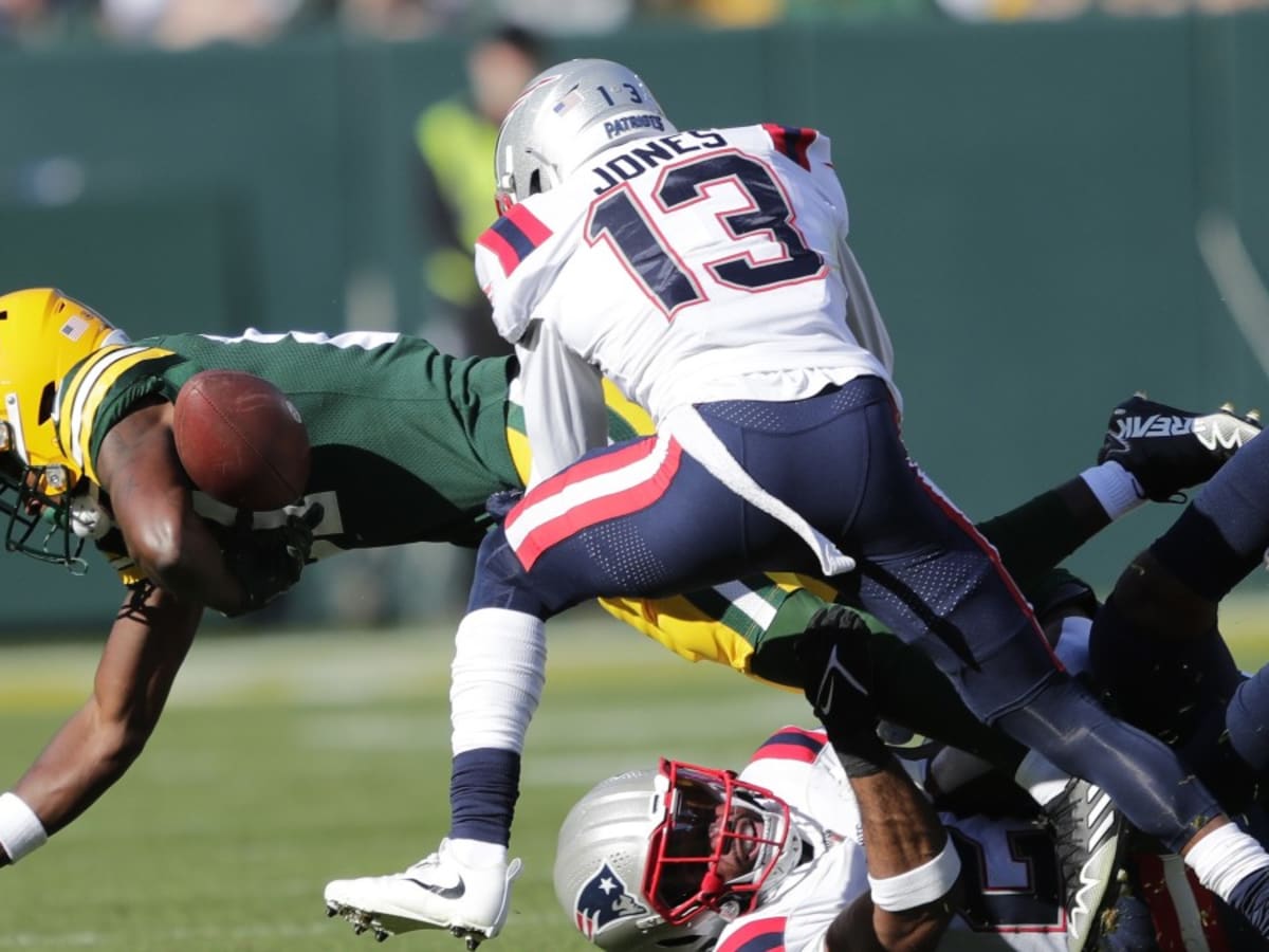 October 2, 2022: Green Bay Packers wide receiver Christian Watson (9)  scoring a touchdown during the NFL football game between the New England  Patriots and the Green Bay Packers at Lambeau Field