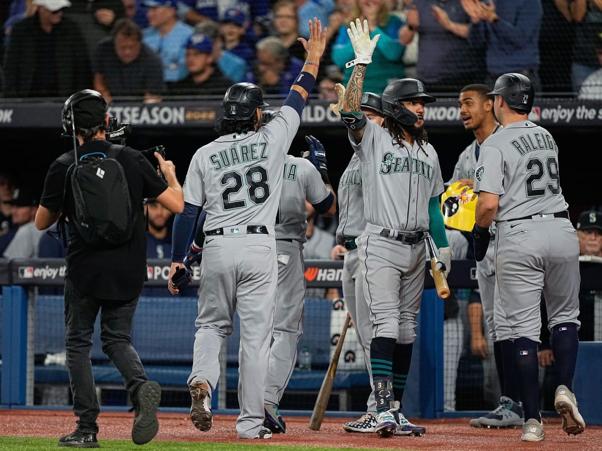 Seattle Mariners' J.P. Crawford (3) carries his gear to the on