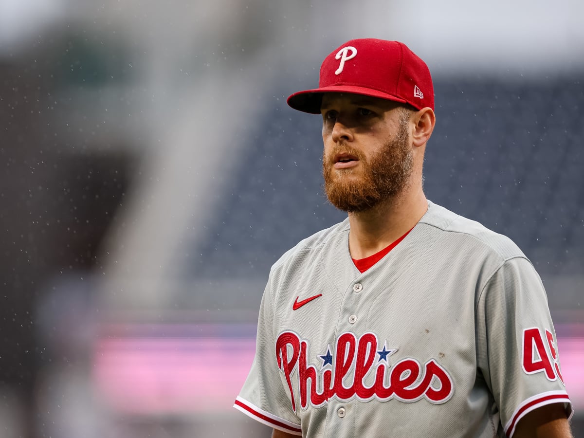 Philadelphia Phillies - Zack Wheeler, wearing the red pinstripe uniform,  about to throw a pitch.