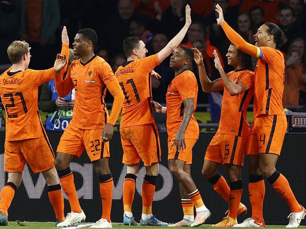  The image shows the early Netherlands football team celebrating a goal against France.