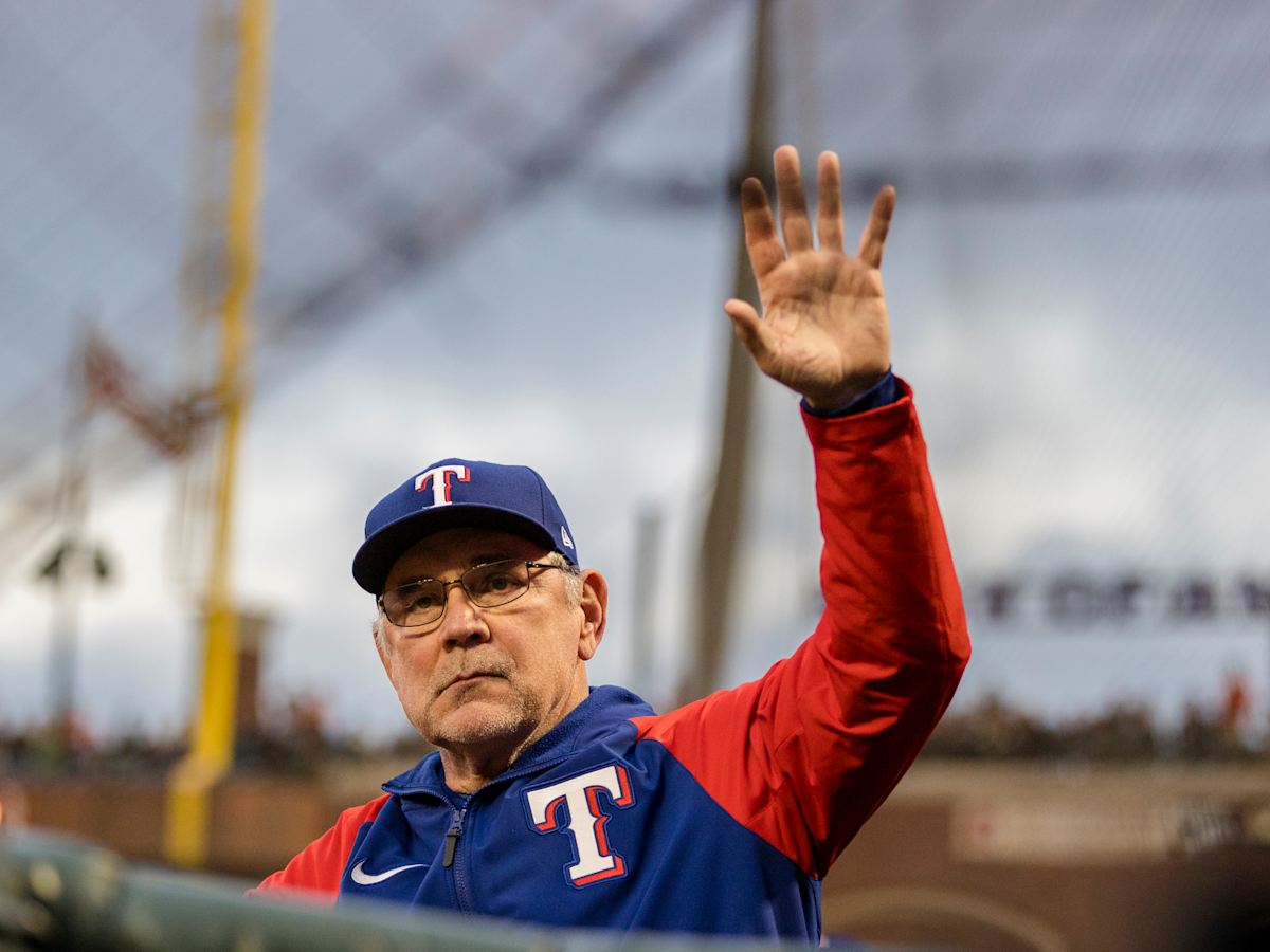 Texas Rangers manager Bruce Bochy walks to the mound to relieve