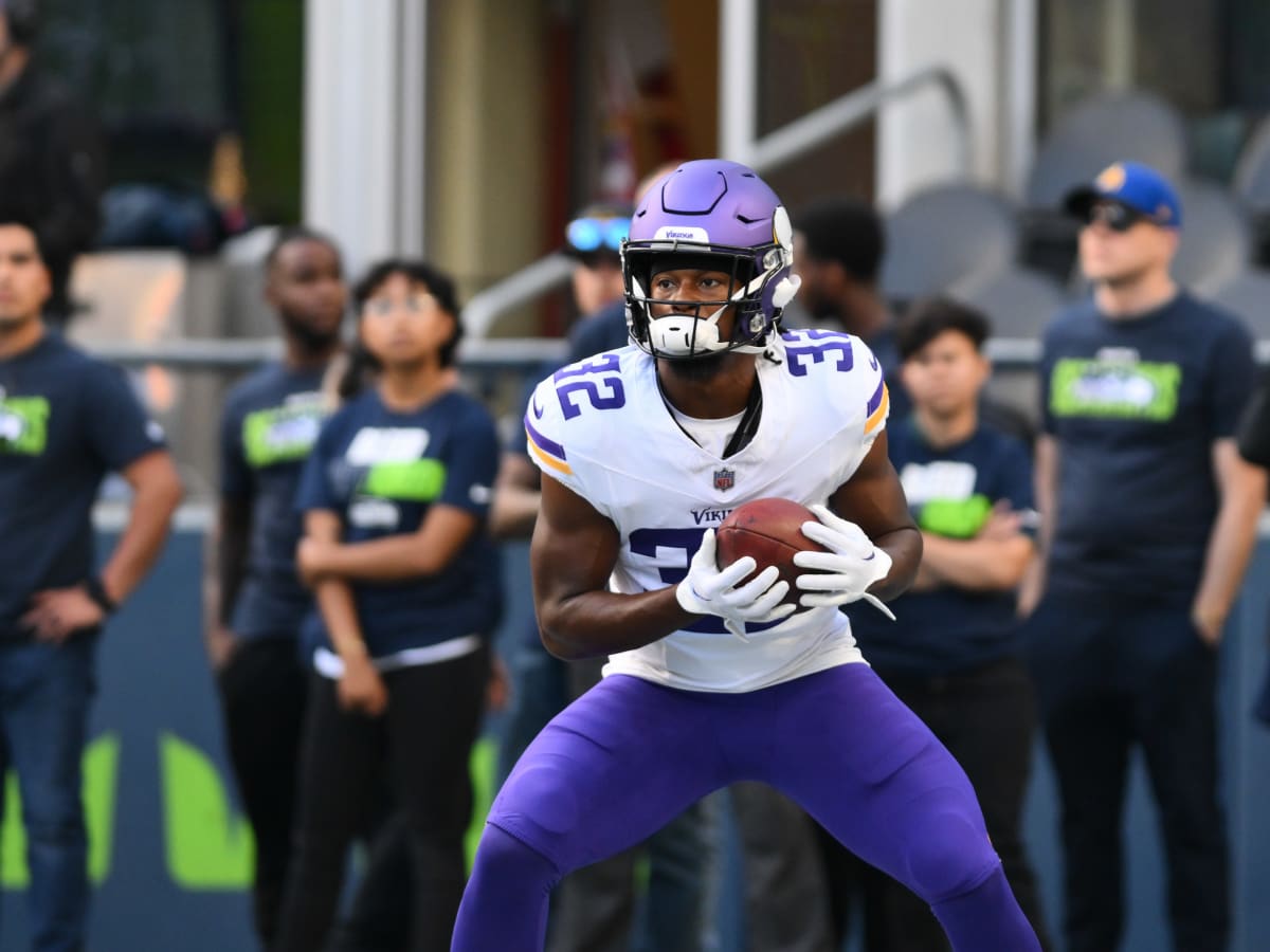 Ty Chandler of the Minnesota Vikings carries the ball against the