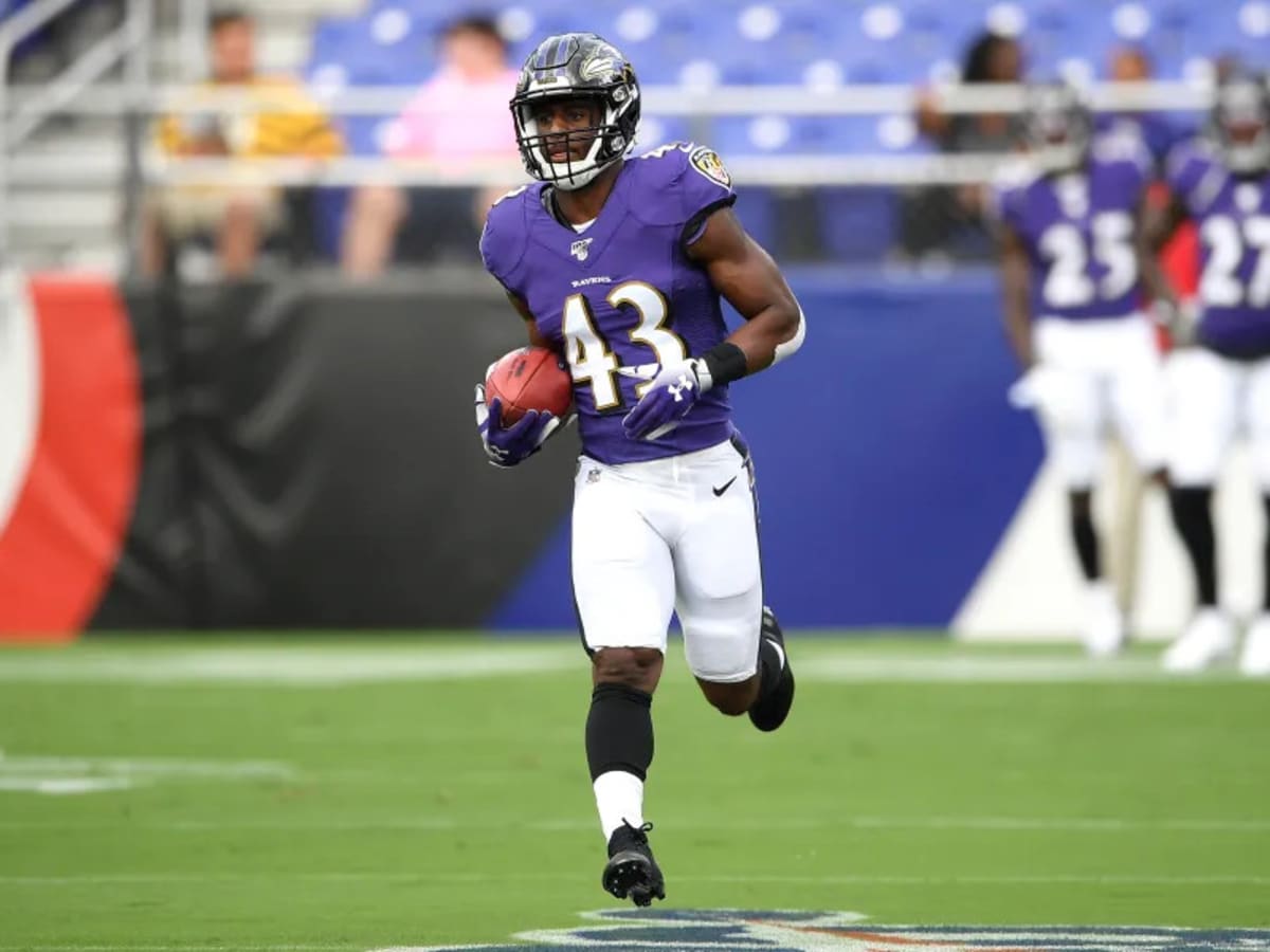 Baltimore Ravens running back Justice Hill, right, celebrates his