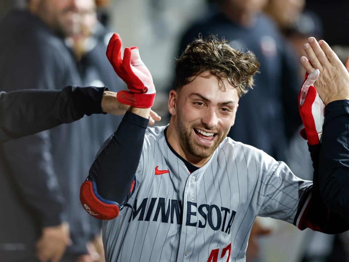 Minnesota Twins' Edouard Julien wears a fishing vest in the dugout