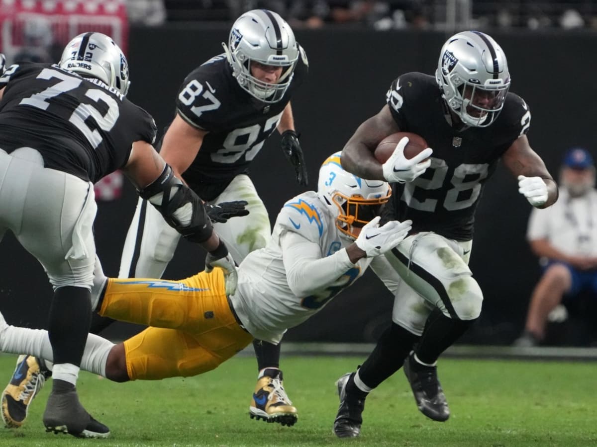 Las Vegas Raiders running back Josh Jacobs (28) gains yards on a run during  an NFL football game against the Los Angeles Chargers, Sunday, September  11, 2022 in Inglewood, Calif. The Chargers