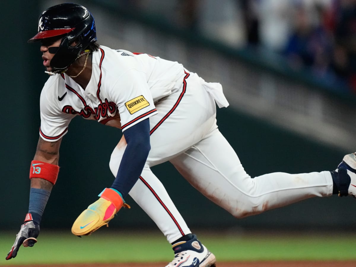 Dansby Swanson of the Chicago Cubs misses the tag on Ronald Acuna Jr.  News Photo - Getty Images