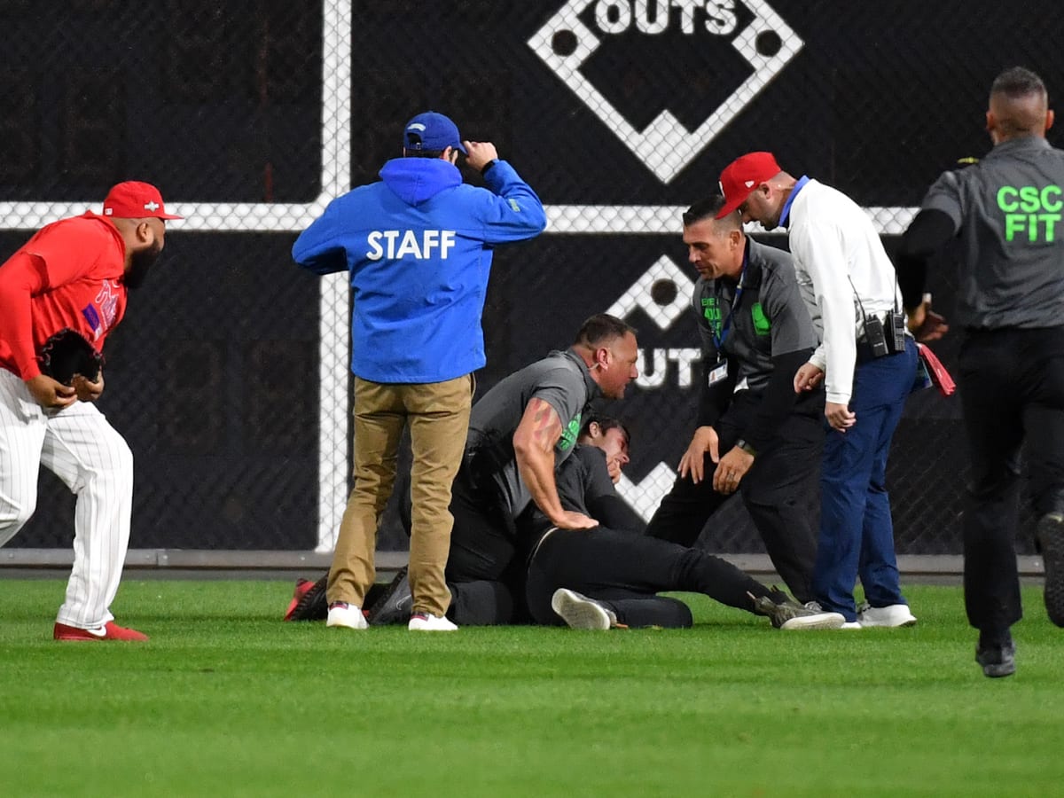 WATCH: Fan tackled hard by security guard on field during Phillies game