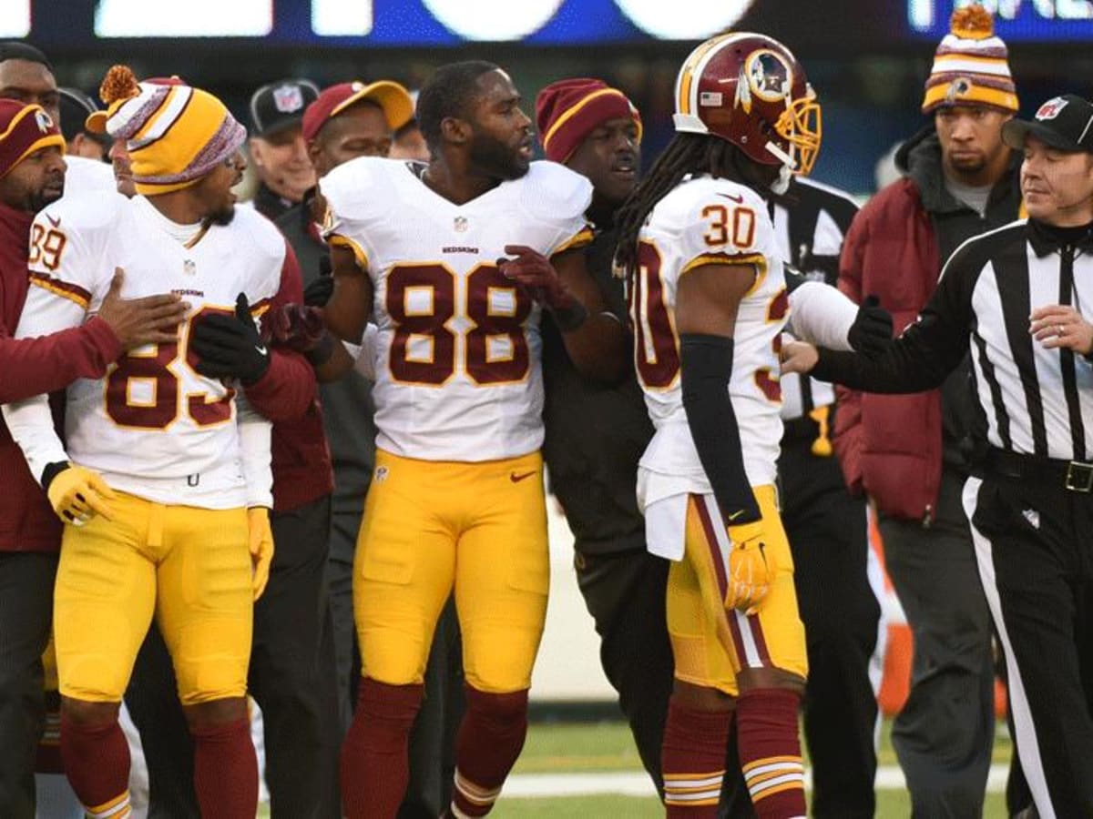 Washington Redskins' Santana Moss, right, lands in the end zone