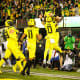 Oregon Ducks quarterback Bo Nix celebrates a touchdown with Bucky Irving (0) and his teammates.