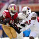 San Francisco 49ers wide receiver Brandon Aiyuk (11) holds onto the ball after making a catch next to Arizona Cardinals cornerback Marco Wilson (20) and safety Jalen Thompson (34) in the second quarter at Levi's Stadium.