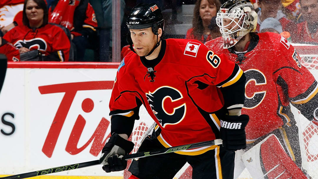 Watch: Flames’ Wideman knocks down official on way to bench