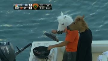 Just two Giants fans wearing horse masks and grilling sausages