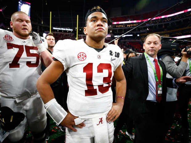 Tua Tagovailoa Alabama Crimson Tide Fanatics Authentic Unsigned White Jersey  Holding Up National Championship Trophy Photograph