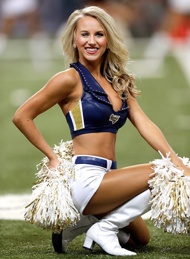 St. Louis Rams cheerleaders sign their swimsuit calendar for a fan