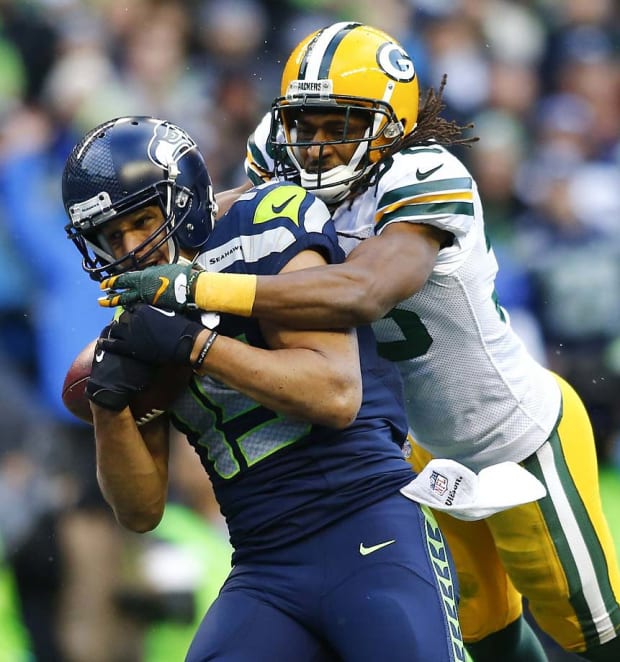 Richard Sherman (25) of the Seattle Seahawks intercepts a pass away from  Davante Adams (17) of the Green Bay Packers in the NFC Championship game at  CenturyLink Field in Seattle, Washington on