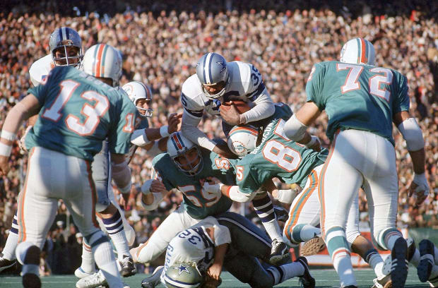 Dan Marino absorbs a big hit from San Francisco 49ers defensive tackle Gary  Johnson. Marino completed 29 of 50 passes for 318 yards and a touchdown but  his Miami Dolphins fell 38-16.