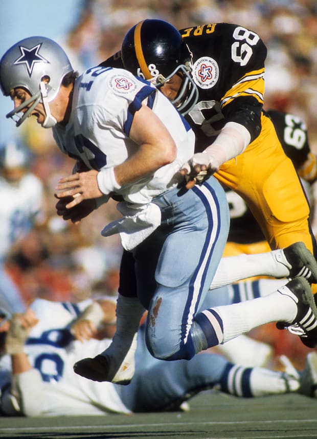 Roger Staubach, Dallas Cowboys' quarterback, scrambles his way to a first  down when all of his receivers were covered. Jim Marshall (70) Minnesota  Vikings' end, chases Staubach. Staubach covered 9 yards on