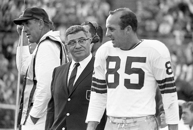 Green Bay Packers' Carroll Dale (84) is pushed and tripped out of