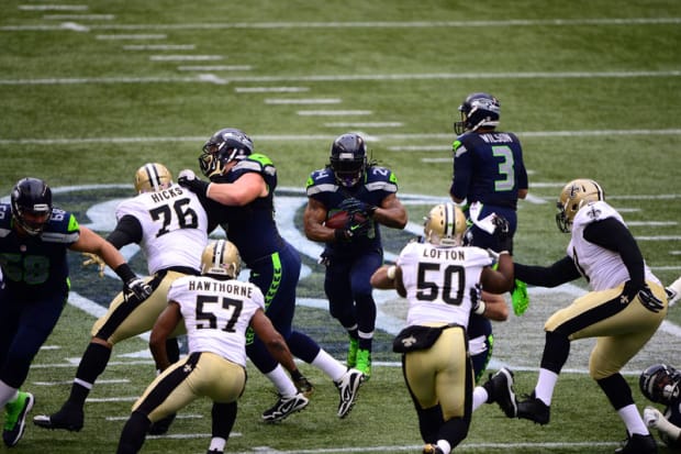 Seattle Seahawks running back Marshawn Lynch (24) walks the sidelines as he  sits out the fourth quarter in the against the New Orleans Saints at  CenturyLink Field in Seattle, Washington on December