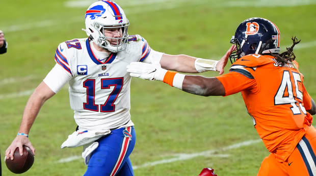 Josh Allen of the Buffalo Bills stiff-arms Jason McCourty of the