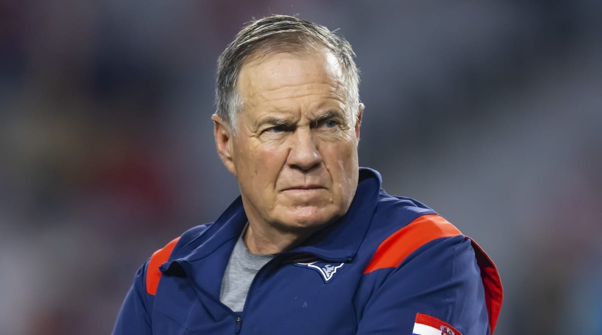 New England Patriots head coach Bill Belichick stands on the field