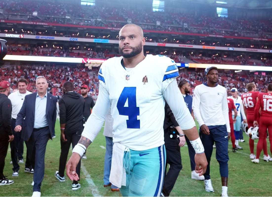 A referee signals Dallas Cowboys football after recovering a