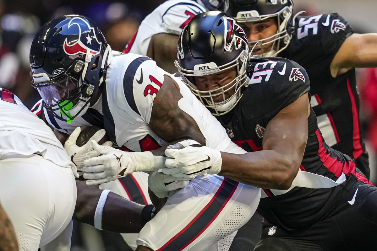 The Atlanta Falcons huddle during the first half of an NFL