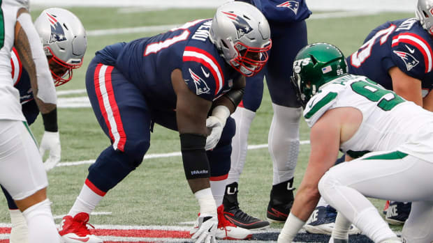 New England Patriots guard Mike Onwenu (71) walks back to the