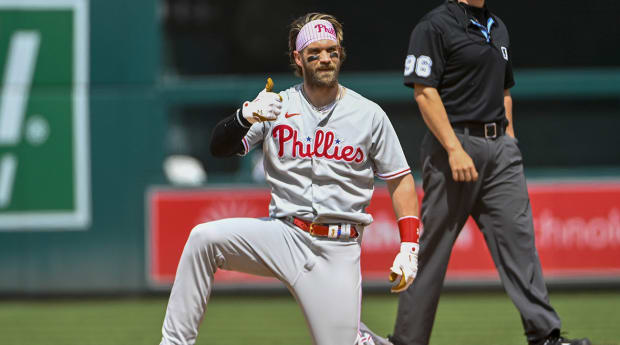 Philadelphia Phillies' Bryce Harper, right, watches his grand slam