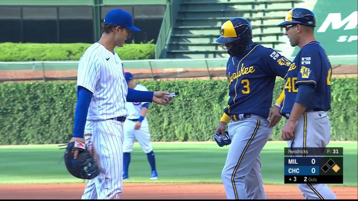 Cubs' Anthony Rizzo Lends Hand Sanitizer to Brewers' Orlando Arcia