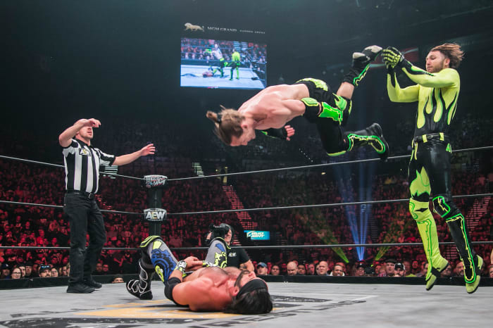 South African luchador Angélico (standing) and his American tag team partner Jack Evans. 