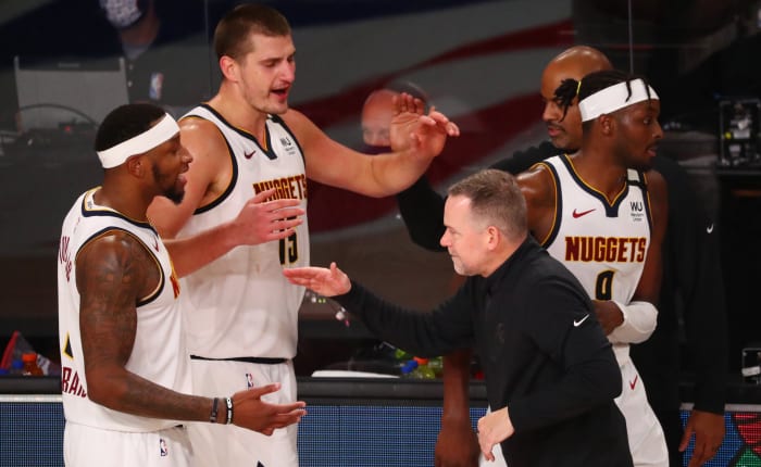 Denver Nuggets head coach Michael Malone celebrates with his team after defeating the Los Angeles Clippers in the seventh game of the second round of the 2020 NBA Playoffs