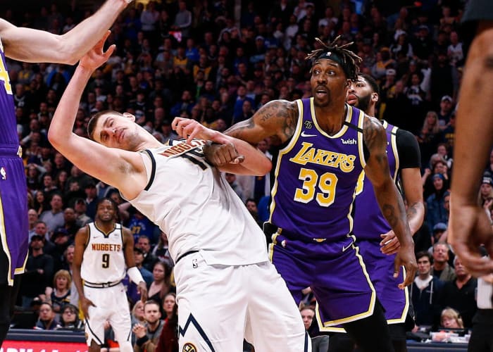 Denver Nuggets center Nikola Jokic (15) battles for a rebound against Los Angeles Lakers guard Alex Caruso (4) and center Dwight Howard (39) in overtime at the Pepsi Center.