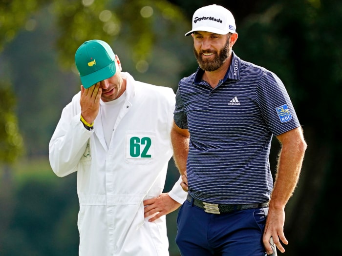 Dustin Johnson reacts with his junior and brother Austin Johnson after winning The Masters golf tournament