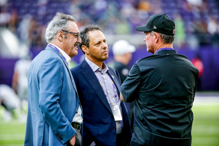 Vikings owners Zygi Wilf, Mark Wilf and Vikings coach talk before a game in 2019