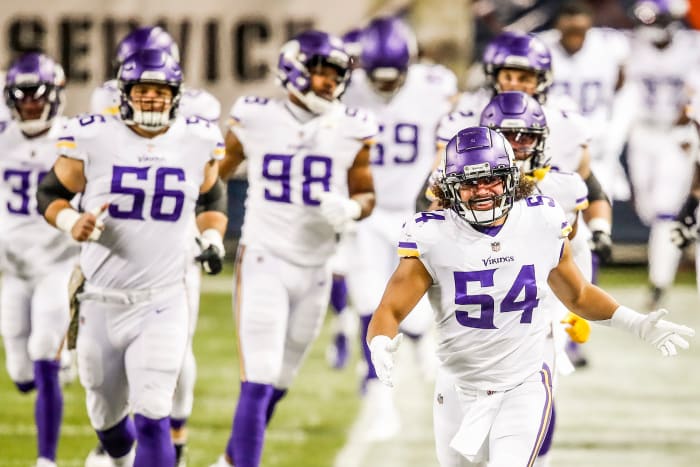 Eric Kendricks leads the Vikings onto the field for a road game